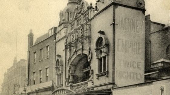 A photo of the outside of Hackney Empire when it opened in 1901 showing members of the public and a horse and cart going past.