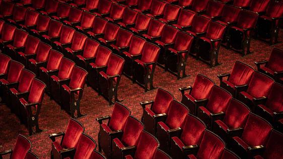 A photo taken from the Dress Circle looking down on rows of chairs in the Stalls.