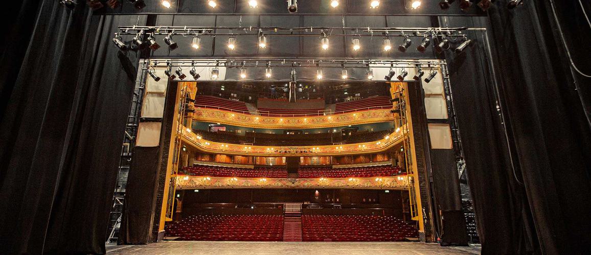 A photo taken from the very back of the stage, showing the whole stage space and the auditorium behind it.