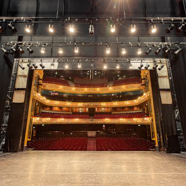 A photo taken from the very back of the stage, showing the whole stage space and the auditorium behind it.