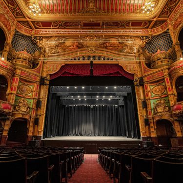 Photo taken from the back of stalls capturing the whole auditorium