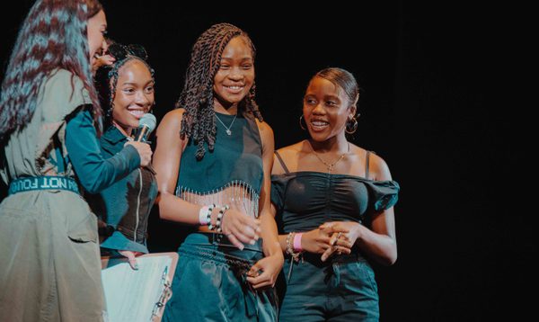 Girl group FCA on stage talking to the host Jess Iszatt about their performance