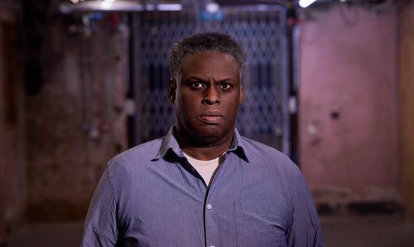 Wills Morgan photographed at Shoreditch Town Hall wearing a blue shirt and staring straight at the camera.