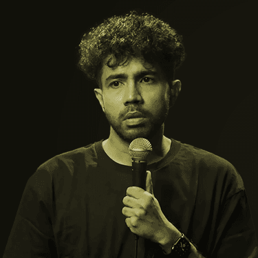 Image of Abhishek Upmanyu holding a microphone up to his mouth.