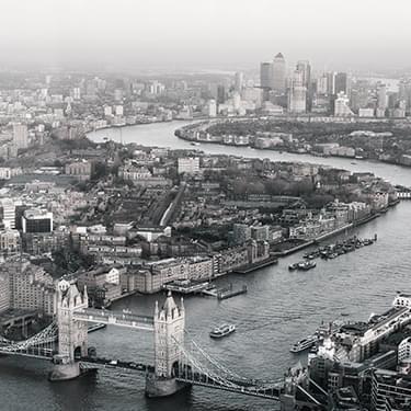 A black and white photo of London showing Tower Bridge and the Thames.