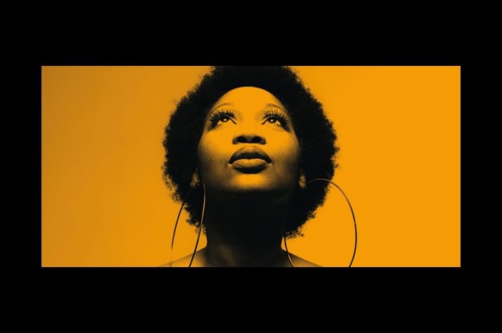 The artwork for The Blessing with a photo of Terri Walker's face looking up with an orange tint across the photo and background