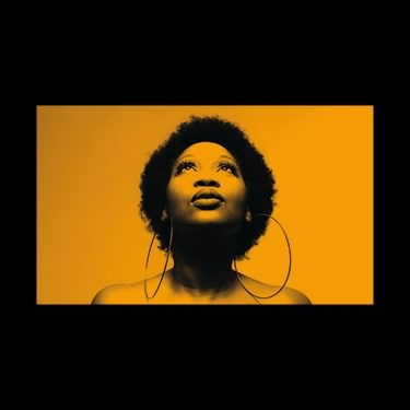 The artwork for The Blessing with a photo of Terri Walker's face looking up with an orange tint across the photo and background