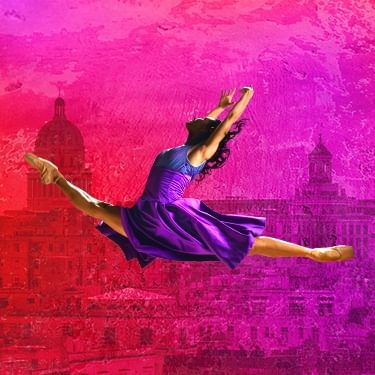 A ballet dancer wearing a purple gown is in mid air in a jump split with their arms above their heads. Behind them is a city background in red/pink.