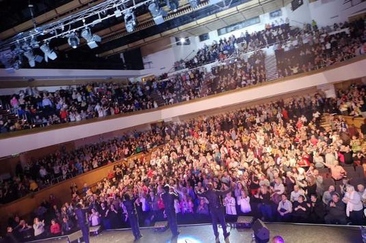 The Drifters performing on stage in front of a live audience.