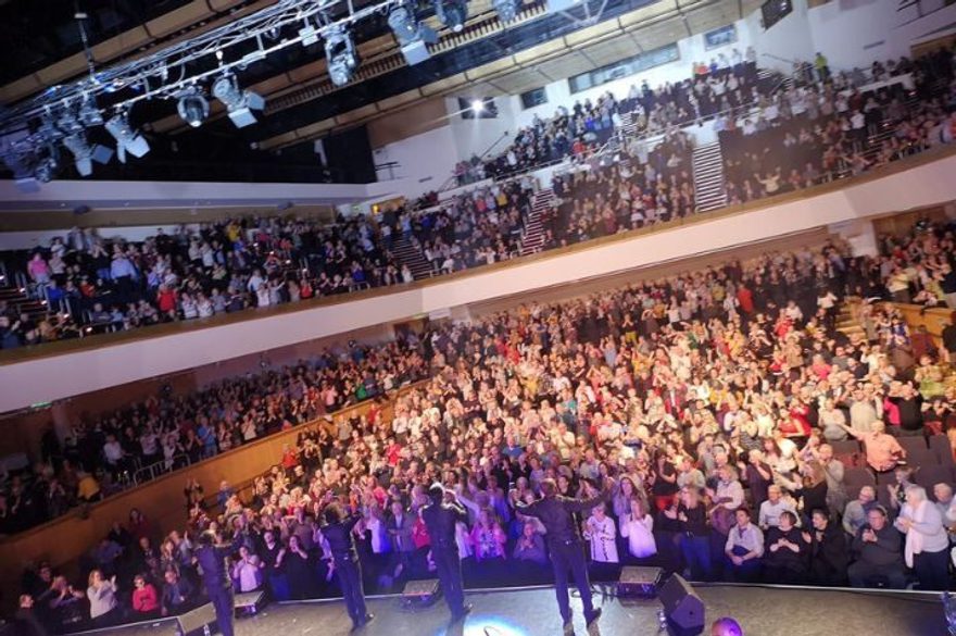 The Drifters performing on stage in front of a live audience.