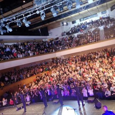 The Drifters performing on stage in front of a live audience.