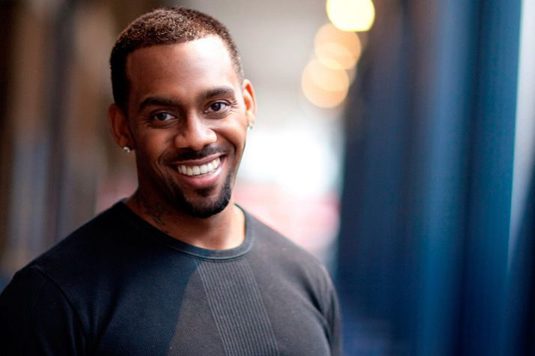 A photo of Richard Blackwood smiling at camera.