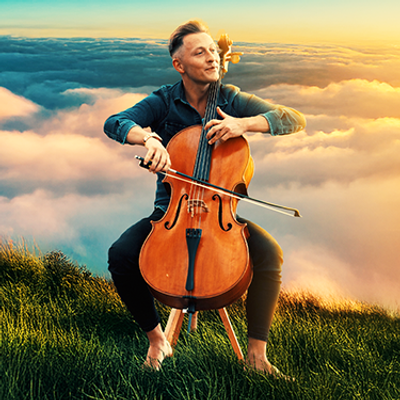 A musician plays a cello while seated on a grassy hill above the clouds, with a vibrant sunset illuminating the scene.