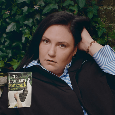 Lena Dunham, a white woman with brown eyes, is sweeping her long, dark brown hair back with her left hand. She is wearing a blue button-down shirt and a black jacket on top. There is a garden wall and ivy in the background. The cover of her memoir is superimposed on the bottom right-hand side. It shows a young woman dressed in a pale skirt, white tights and black mary jane shoes falling down the stairs of a garden path.
