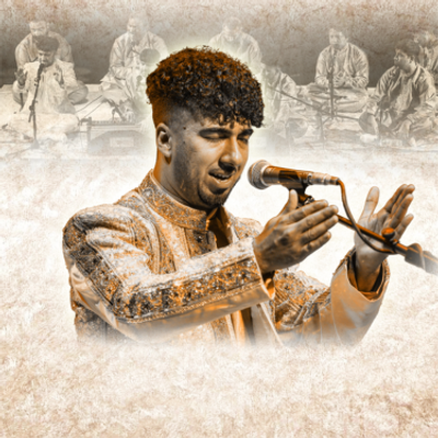 Chand Ali Khan is in a gold outfit and is singing into the microphone with his eyes and hands on either side of the microphone in the air.