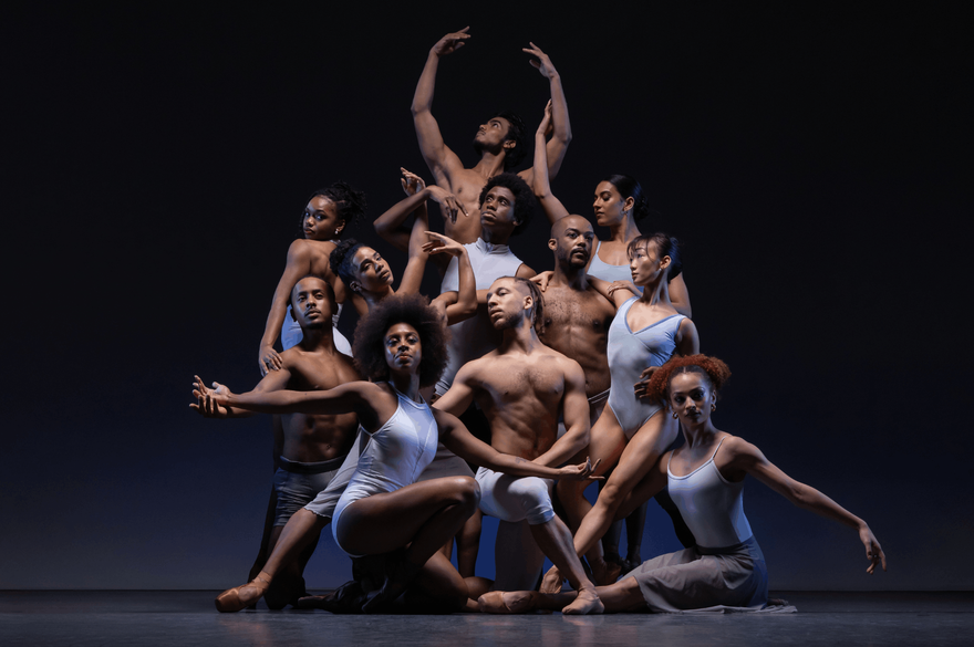 A group of dancers strikes a pose for a photo, displaying their colorful attire and enthusiastic expressions.