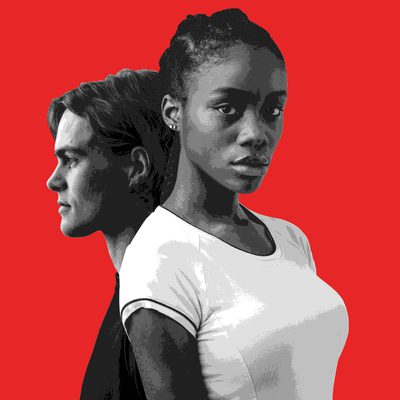 A black and white image of two young adults on a red background, a white male and a black female. The boy is positioned in profile behind the girl. She is wearing a white t-shirt and looking directly at the viewer.