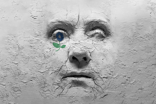 A mural depicting a woman's face, showcasing vibrant colors and intricate details on a textured wall.