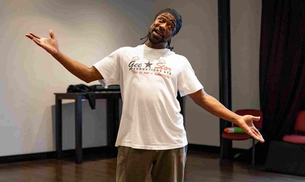 Kat B as one of the Ugly Sister is posing with arms outstretched