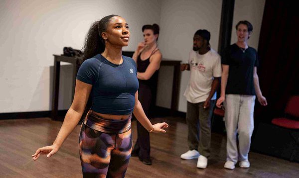 Siobhan James as Cinderella is looking up at the air with a hopeful expression