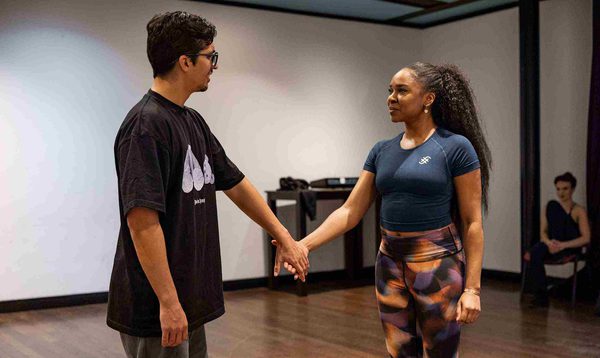 Luke Latchman as Prince Charming and Siobhan James as Cinderella standing holding hands