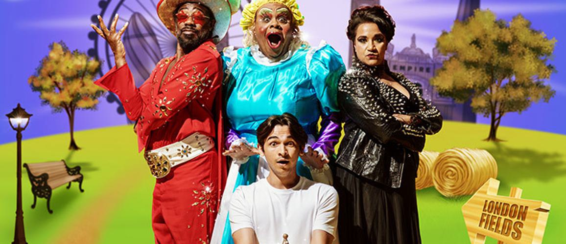 A photo of Kat B as the Genie, Clive Rowe as Widow Twankey, Fred Double as Aladdin and Natasha Lewis as Abby-na-zaaar! They are all posing together against a purple and grassy background around Aladdin, who is holding the lamp.