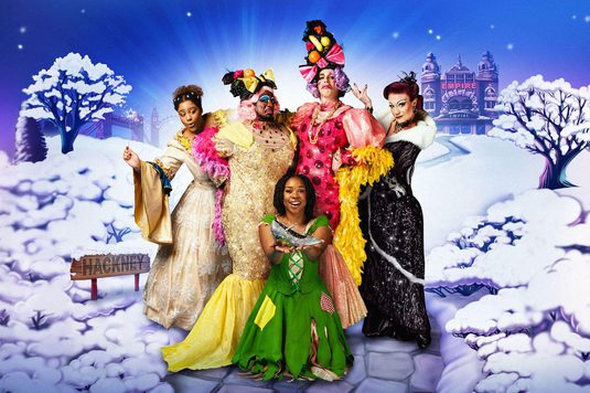 The final cast artwork for Cinderella with the Fairy Godmother, the Ugly Sisters, Cinderella and the Wicked Stepmother posing together against a snowy background with Hackney Empire behind them.