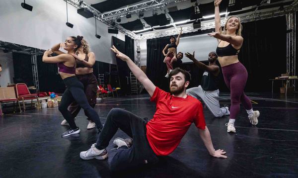 The Dick Whittington and his Cat Ensemble in various poses and at different levels during a dance
