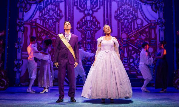 Luke Latchman as Prince Charming and Siobhan James as Cinderella stand side by side at the Ball with loving expressions on their faces.