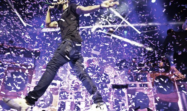A photo of Rudimental performing at Hackney Empire surrounded by paper confetti