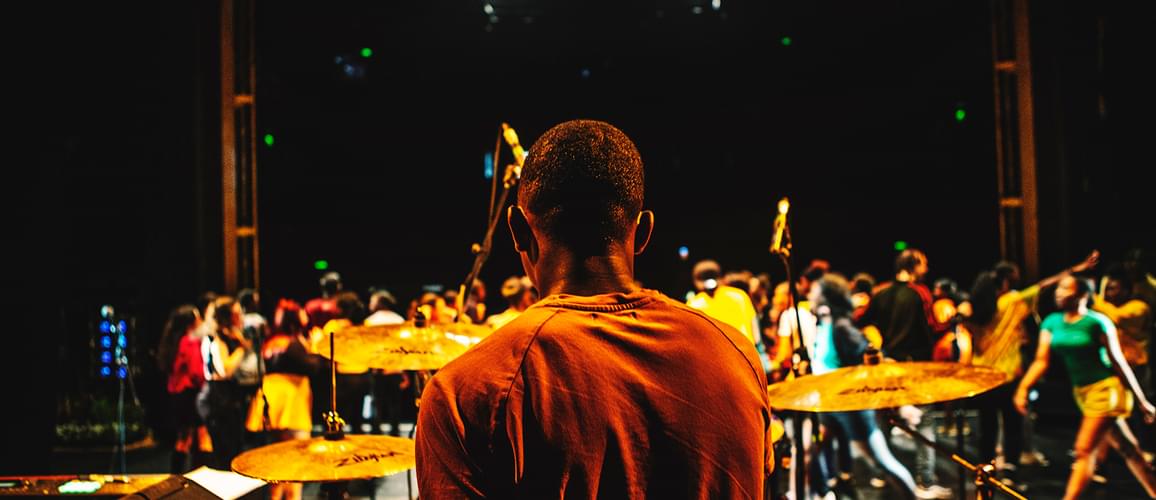 this picture is taken behind a drummer sitting at the back of Hackney Empire main stage. You can see the cast performing in front of him.