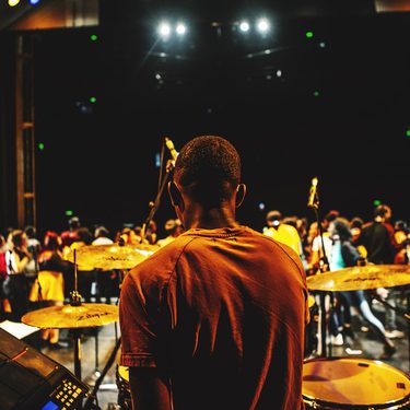 this picture is taken behind a drummer sitting at the back of Hackney Empire main stage. You can see the cast performing in front of him.