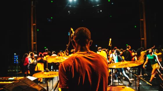 this picture is taken behind a drummer sitting at the back of Hackney Empire main stage. You can see the cast performing in front of him.