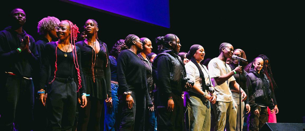 A photo of Hackney Empire Creative Futures cohort on stage together performing a piece of spoken word.