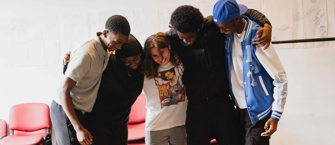 A group of friends hugging as a sense of encouragement to each other