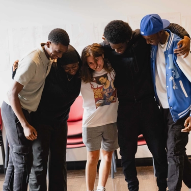 A group of friends hugging as a sense of encouragement to each other