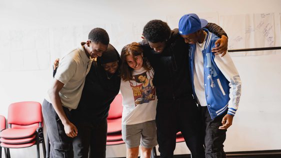 A group of friends hugging as a sense of encouragement to each other