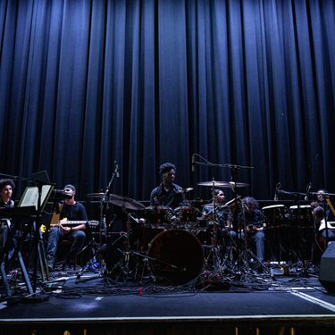 The ADP band are on Hackney Empire's main stage sitting behind their instruments waiting to play