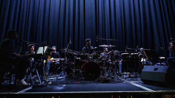 The ADP band are on Hackney Empire's main stage sitting behind their instruments waiting to play